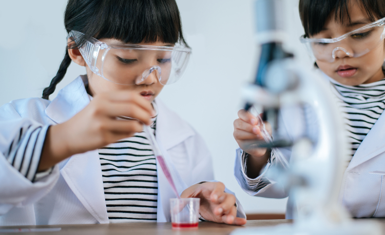 two girls doing science experiments